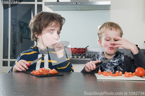 Image of Boys tasting tomato