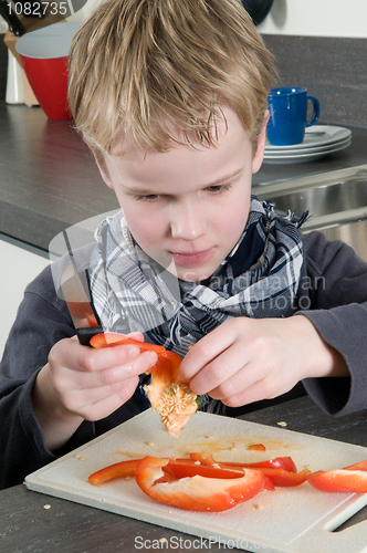 Image of Boy cutting pepper