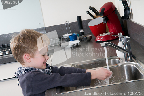 Image of Child washing his hands