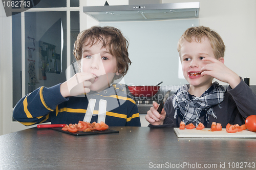 Image of Boys tasting tomato