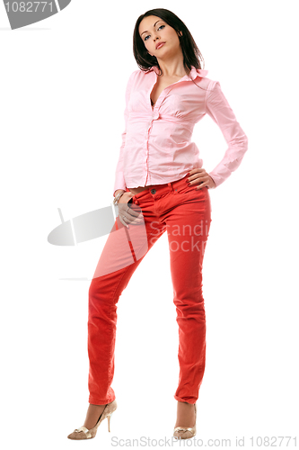 Image of Attractive young brunette in red jeans