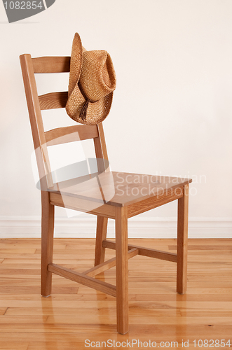 Image of Cowboy hat on a wooden chair