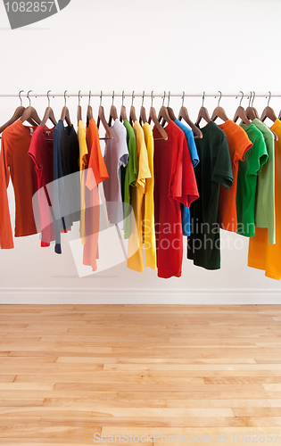 Image of Variety of multicolored clothes on a rod