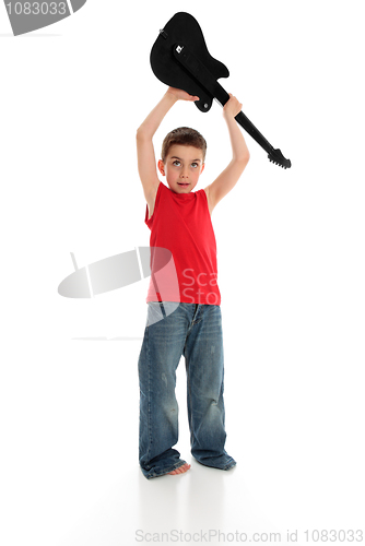 Image of Boy playing holding guitar over head