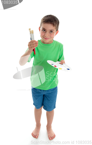 Image of Standing boy holding paints and brushes