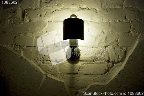 Image of Photo of wall lamp with dim light  