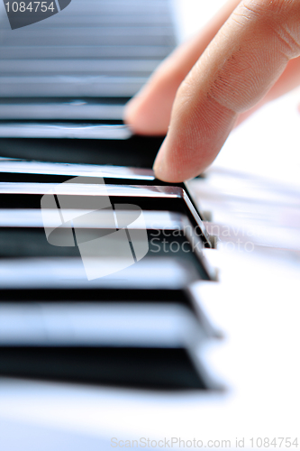 Image of Close up of the hands of a young man playing piano 