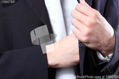 Image of businessman hand in  pocket of a jacket 