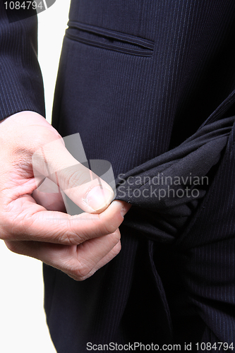 Image of young male shows empty pockets in his trousers, business concept