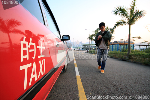 Image of asia man going to take taxi