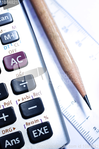 Image of close-up of ruler,calculator,and pencil,focus on pencil-tip