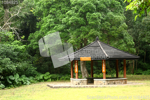 Image of Small pavilion among nature with forest background 
