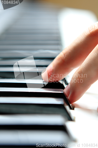 Image of Close up of the hands of a young man playing piano 