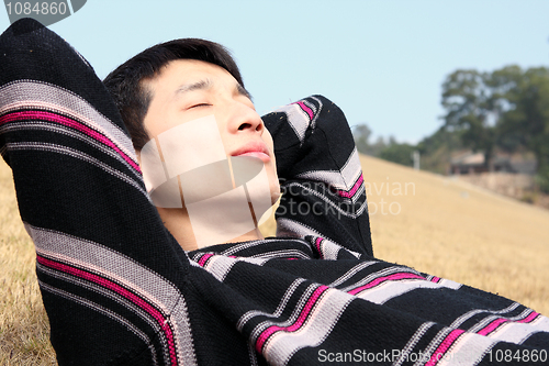 Image of Man lying in yellow grass