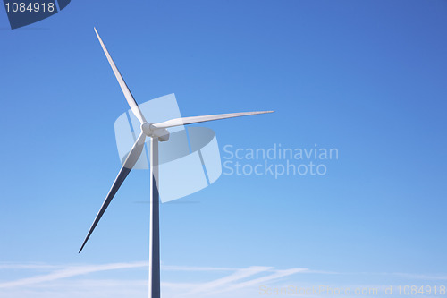 Image of wind mill power, isolated on blue sky;