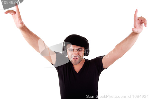 Image of man listening music in headphones, arms raised