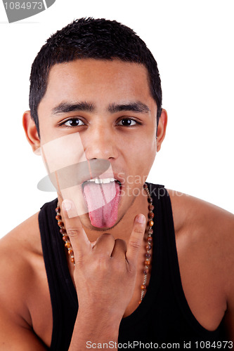 Image of Young latin man with thumbs raised as cool signal making "funny face"