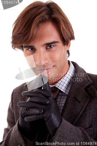 Image of Portrait of a happy young businessman, in autumn/winter clothes