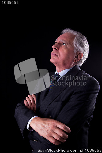 Image of Portrait of a handsome mature businessman, looking up thinking,
