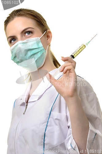 Image of  paramedic in mask with syringe