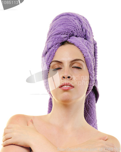 Image of woman with closed eyes and her hair wrapped into light violet ba