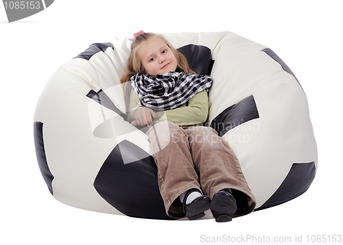 Image of Girl sitting on an inflatable chair in the form of a soccer ball