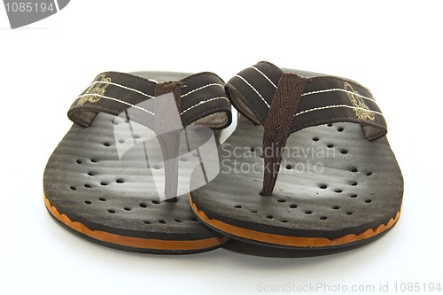 Image of Brown flip flops on a white background