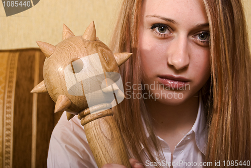 Image of young girl with a cudgel 