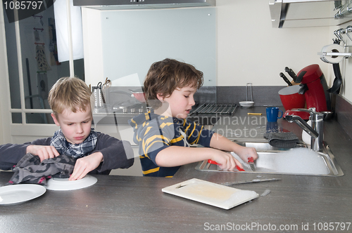 Image of Two boys doing the dishes