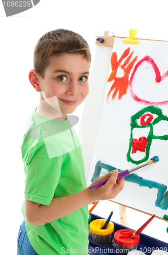 Image of Young boy artist painting at easel