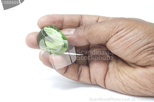 Image of Hand holding a beautiful green marble