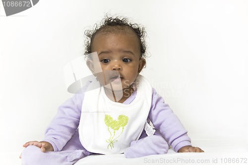 Image of Baby girl learning to sit