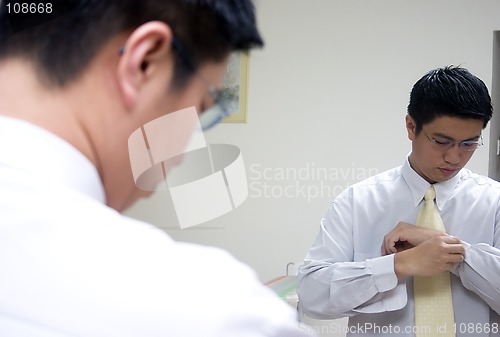 Image of Young Asian Man Preparing To Work