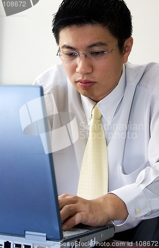 Image of Young Asian Entrepreneur Working with Computer