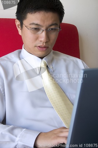 Image of Young Asian Entrepreneur Working with Computer