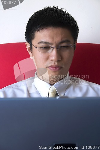 Image of Young Asian Entrepreneur Working with Computer