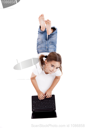Image of Little student girl with a laptop