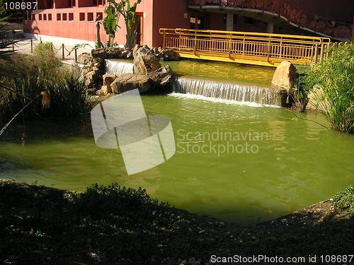 Image of bridge over pond waterfall