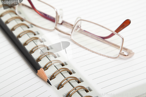 Image of Diary, pencil and glasses