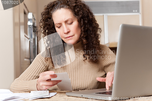 Image of Woman paying bills