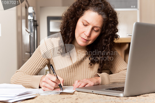 Image of Woman paying bills