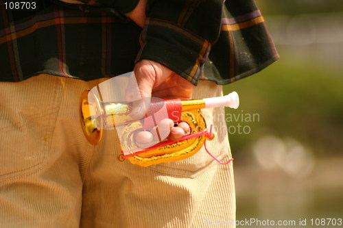 Image of childs trumpet in a mans hand