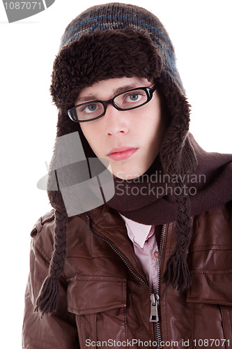 Image of Young boy looking serious, with winter clothes, glasses and hat