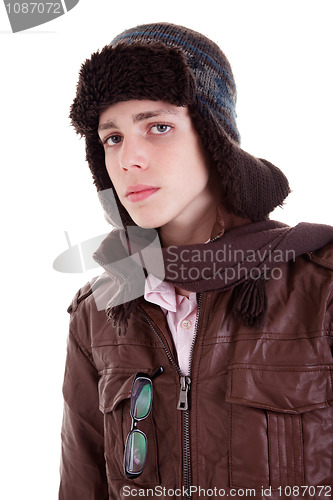 Image of Young boy looking serious, with hat and winter clothes