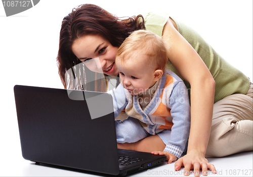 Image of Mother an her son are playing with laptop
