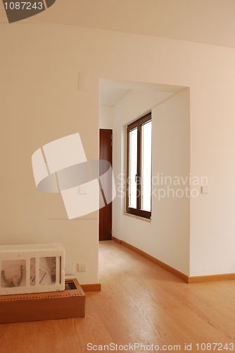 Image of Empty living room with wooden floor and some boxes