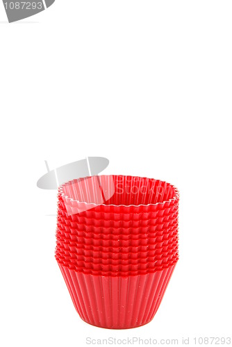 Image of Red plastic cups for small cakes on white