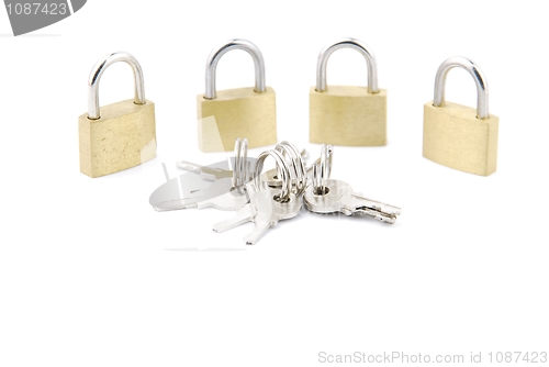 Image of Golden closed padlocks with keys on white