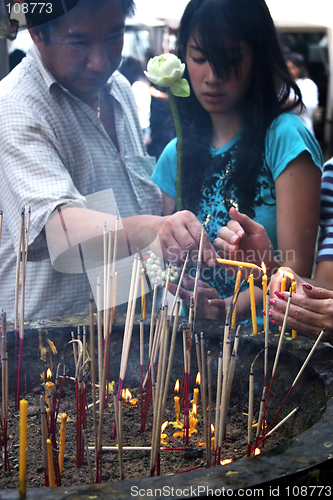 Image of People light incense at a temple in Bangkok, Thailand