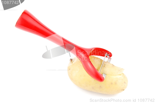 Image of Peeling a potato with peeler on white